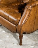 distressed saddle leather recliner with button tufting on seat and back