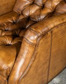 distressed saddle leather recliner with button tufting on seat and back