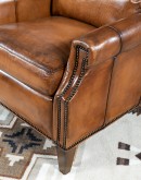 Brown Leather Recliner with full-grain leather, hand-burnished details, brass nail tacks, and bustle back design for optimal comfort.