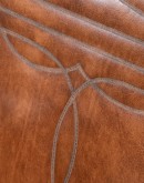 A brown leather recliner chair with a wooden base and armrests is pictured against a plain beige background. The chair has a tight back with a boot stitch emblem and is adorned with premium upholstery grade brindle cowhide on the sides and outside back. T