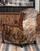 A brown leather recliner chair with a wooden base and armrests is pictured against a plain beige background. The chair has a tight back with a boot stitch emblem and is adorned with premium upholstery grade brindle cowhide on the sides and outside back. T