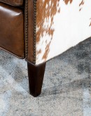 brown saddle recliner with speckled cowhide accents