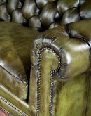 American-made Berkshire Olive Chesterfield Sofa with hand burnished full-grain leather and brass nail tacks detailing, showcasing traditional craftsmanship.