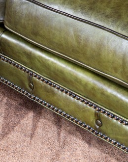 American-made Berkshire Olive Chesterfield Sofa with hand burnished full-grain leather and brass nail tacks detailing, showcasing traditional craftsmanship.