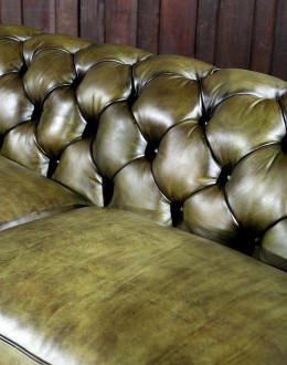 American-made Berkshire Olive Chesterfield Sofa with hand burnished full-grain leather and brass nail tacks detailing, showcasing traditional craftsmanship.