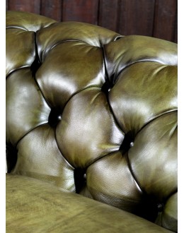 American-made Berkshire Olive Chesterfield Sofa with hand burnished full-grain leather and brass nail tacks detailing, showcasing traditional craftsmanship.