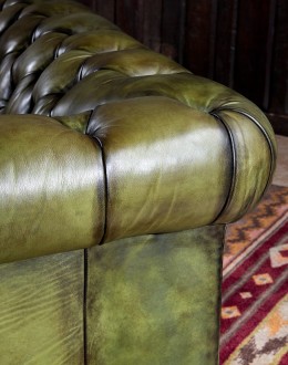 American-made Berkshire Olive Chesterfield Sofa with hand burnished full-grain leather and brass nail tacks detailing, showcasing traditional craftsmanship.