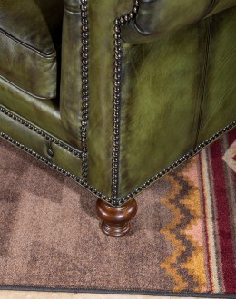 American-made Berkshire Olive Chesterfield Sofa with hand burnished full-grain leather and brass nail tacks detailing, showcasing traditional craftsmanship.