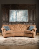 curved leather sofa with tufted seat back in tan distressed leather