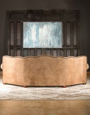 curved leather sofa with tufted seat back in tan distressed leather
