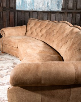 curved leather sofa with tufted seat back in tan distressed leather