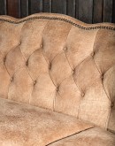 curved leather sofa with tufted seat back in tan distressed leather