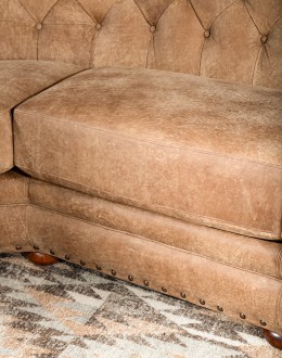curved leather sofa with tufted seat back in tan distressed leather