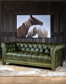 Ivy League Leather Sofa - Modernized Chesterfield style sofa in olive green full grain leather with hand burnished accents, deep button tufts, and brass nail tack trimmings. Experience luxury and timeless elegance