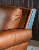 distressed tan leather sofa with denim blue leather accents 