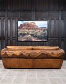 Mountain Mesa Leather Sofa featuring hand-painted mountain landscape, full-grain leather upholstery, and stitched front arm panels, part of Adobe Interiors' Mountain Ranch Collection.