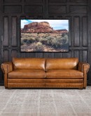 Mountain Mesa Leather Sofa featuring hand-painted mountain landscape, full-grain leather upholstery, and stitched front arm panels, part of Adobe Interiors' Mountain Ranch Collection.