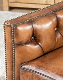 swivel chair with dark tufted leather on inside and southwestern style fabric on outside