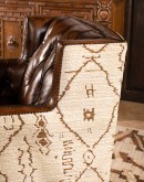 swivel chair with dark tufted leather on inside and southwestern style fabric on outside