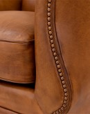swivel glider chair with light brown saddle leather,