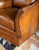 swivel glider chair with light brown saddle leather,
