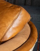 western style leather horseshoe shaped chair with cream shearling on the outside