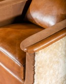 western style leather horseshoe shaped chair with cream shearling on the outside