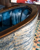 barrel swivel chair with dark blue leather and cowhide on the outside