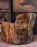 western style leather barrel chair with brindle cowhide on the outside and boot stitch emblem on the seatback.