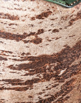 swivel and rocker chair with tufted green leather and cowhide on the outside