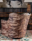 swivel and rocker chair with tufted green leather and cowhide on the outside