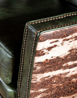 swivel and rocker chair with tufted green leather and cowhide on the outside