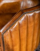 Oliver Leather Swivel Chair in rich full grain leather with hand-burnished details, vertical pocketed channel stitching on back, and American-made 8-way hand-tied craftsmanship