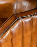 Oliver Leather Swivel Chair in rich full grain leather with hand-burnished details, vertical pocketed channel stitching on back, and American-made 8-way hand-tied craftsmanship