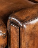 Speakeasy Swivel Chair, a 100% American-made, luxurious full-grain leather chair with a timeless, low-profile design featuring a tufted back, spring down seat cushion, and hand burnished leather accents