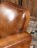 high end Leather Swivel Chair in rich saddle leather, featuring pleated stitched channels, brass nail tacks, and large flat armrests for exceptional comfort.