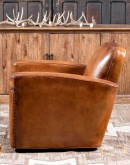 high end Leather Swivel Chair in rich saddle leather, featuring pleated stitched channels, brass nail tacks, and large flat armrests for exceptional comfort.