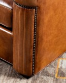 high end Leather Swivel Chair in rich saddle leather, featuring pleated stitched channels, brass nail tacks, and large flat armrests for exceptional comfort.