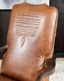 executive desk chair in distressed tan saddle leather with boot stitch design on seat back