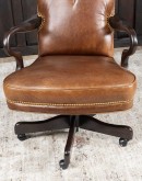 executive desk chair in distressed tan saddle leather with boot stitch design on seat back