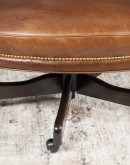 executive desk chair in distressed tan saddle leather with boot stitch design on seat back