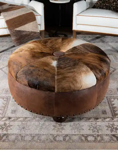 42 inch round ottoman with distressed brown leather and brindle cowhide on top