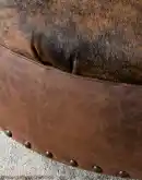 42 inch round ottoman with distressed brown leather and brindle cowhide on top